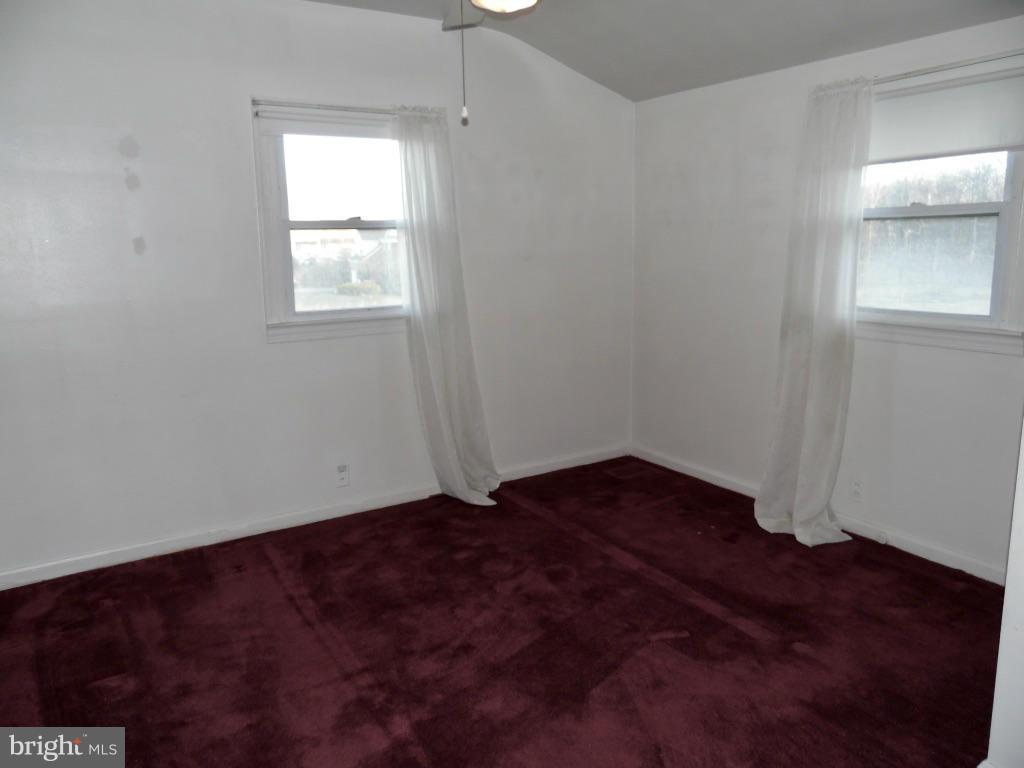11245 Old Frederick Road Marriottsville, MD 21104 - Photo 7 of 22 a view of an empty room with wooden floor and a window