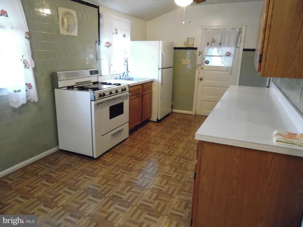 11245 Old Frederick Road Marriottsville, MD 21104 - Photo 8 of 22 a kitchen with stainless steel appliances a stove a sink and a refrigerator