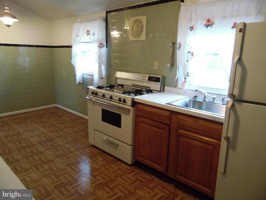 11245 Old Frederick Road Marriottsville, MD 21104 - Photo 10 of 22 a kitchen with a stove and a refrigerator