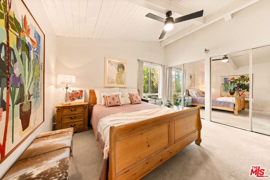 6425 Green Valley Circle, Unit 302 Culver City, CA 90230 - Photo 13 of 34 a large bedroom with a large bed and a chandelier