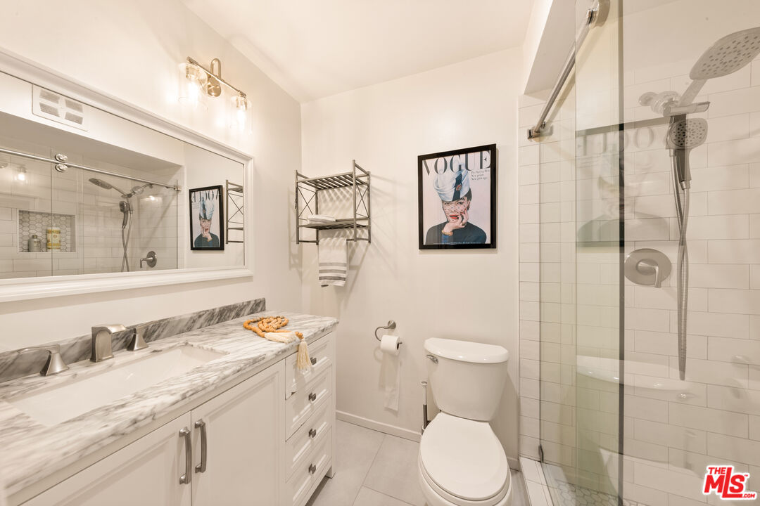 6425 Green Valley Circle, Unit 302 Culver City, CA 90230 - Photo 19 of 34 a bathroom with a granite countertop toilet sink and shower