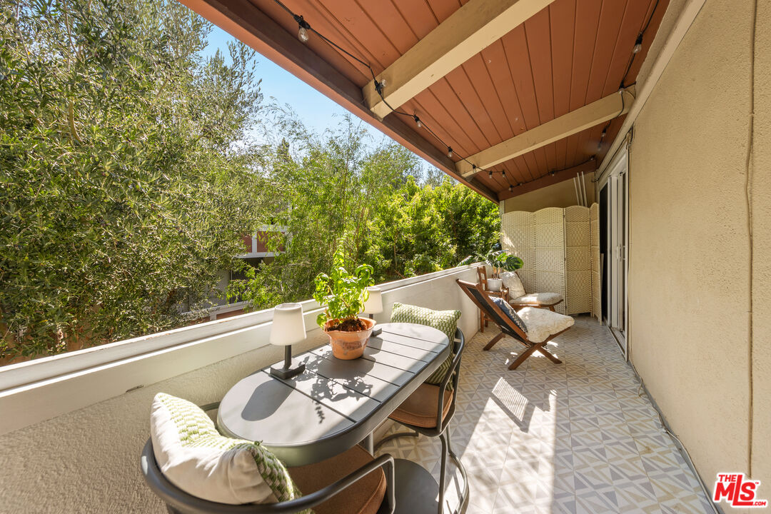 6425 Green Valley Circle, Unit 302 Culver City, CA 90230 - Photo 27 of 34 a balcony with furniture and wooden floor
