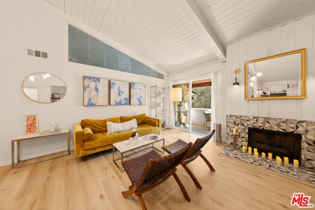 6425 Green Valley Circle, Unit 302 Culver City, CA 90230 - Photo 4 of 34 a living room with furniture and a fireplace