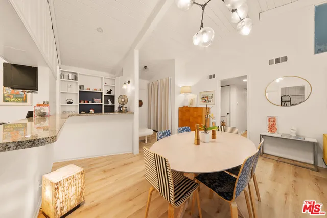 a dining room with furniture and wooden floor