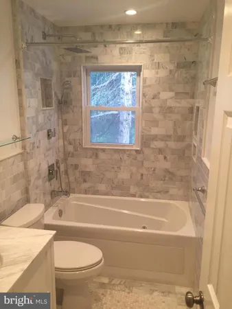 a bathroom with a toilet and a bathtub