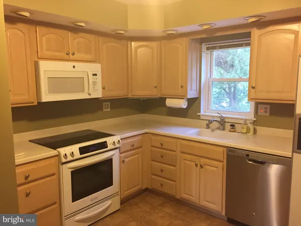a kitchen with a sink stove and microwave