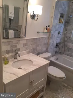 a bathroom with a sink a toilet and bathtub