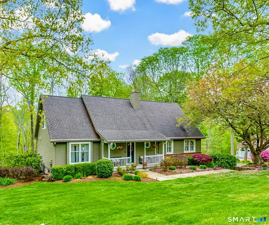 a front view of a house with a yard and outdoor seating