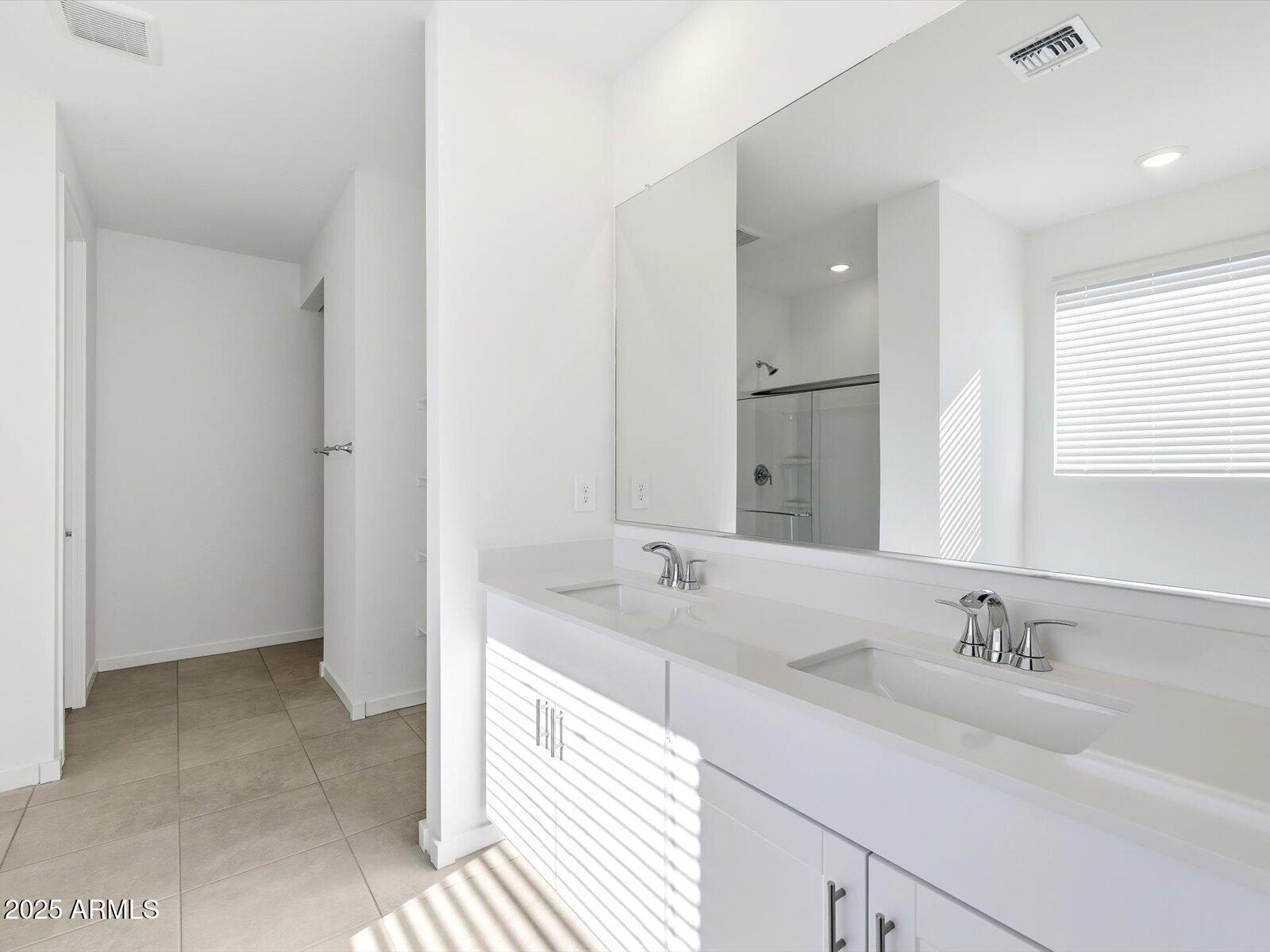 24477 West Grove Street Buckeye, AZ 85326 - Photo 14 of 49 a bathroom with a sink and a mirror