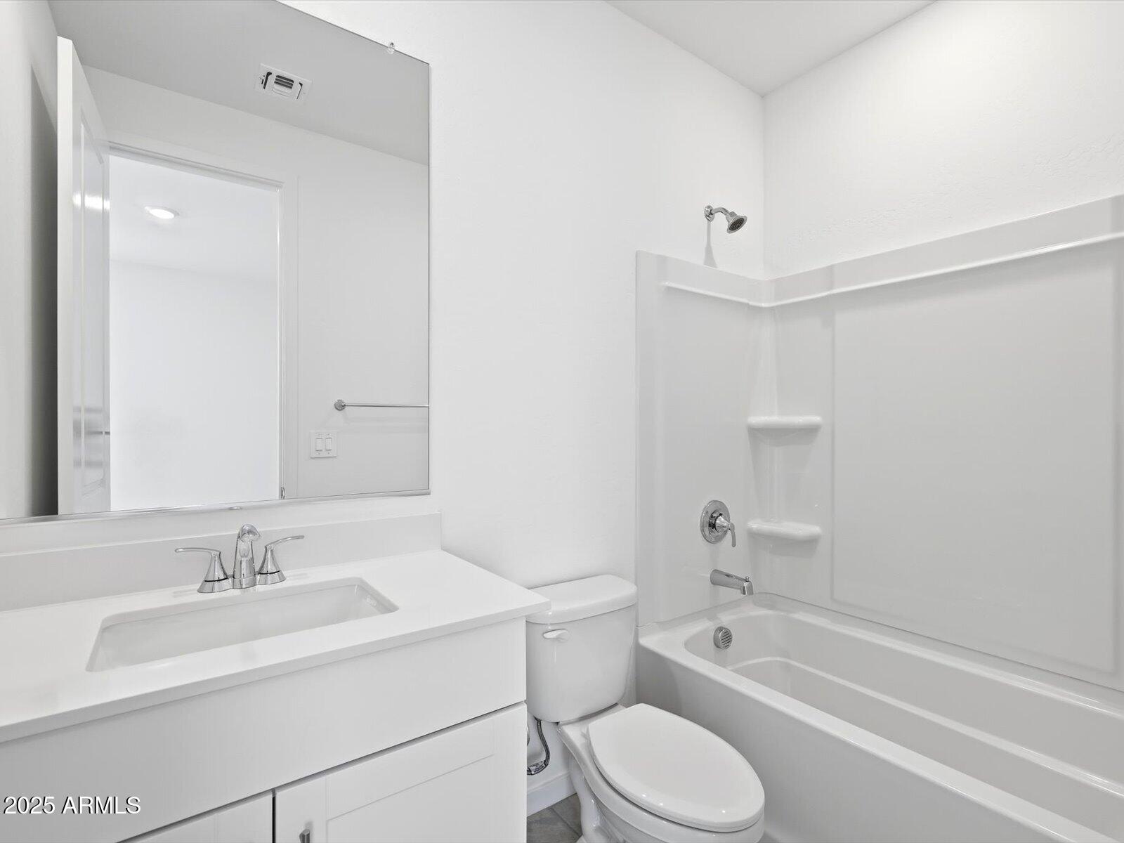 24477 West Grove Street Buckeye, AZ 85326 - Photo 18 of 49 a bathroom with a sink toilet vanity and tub