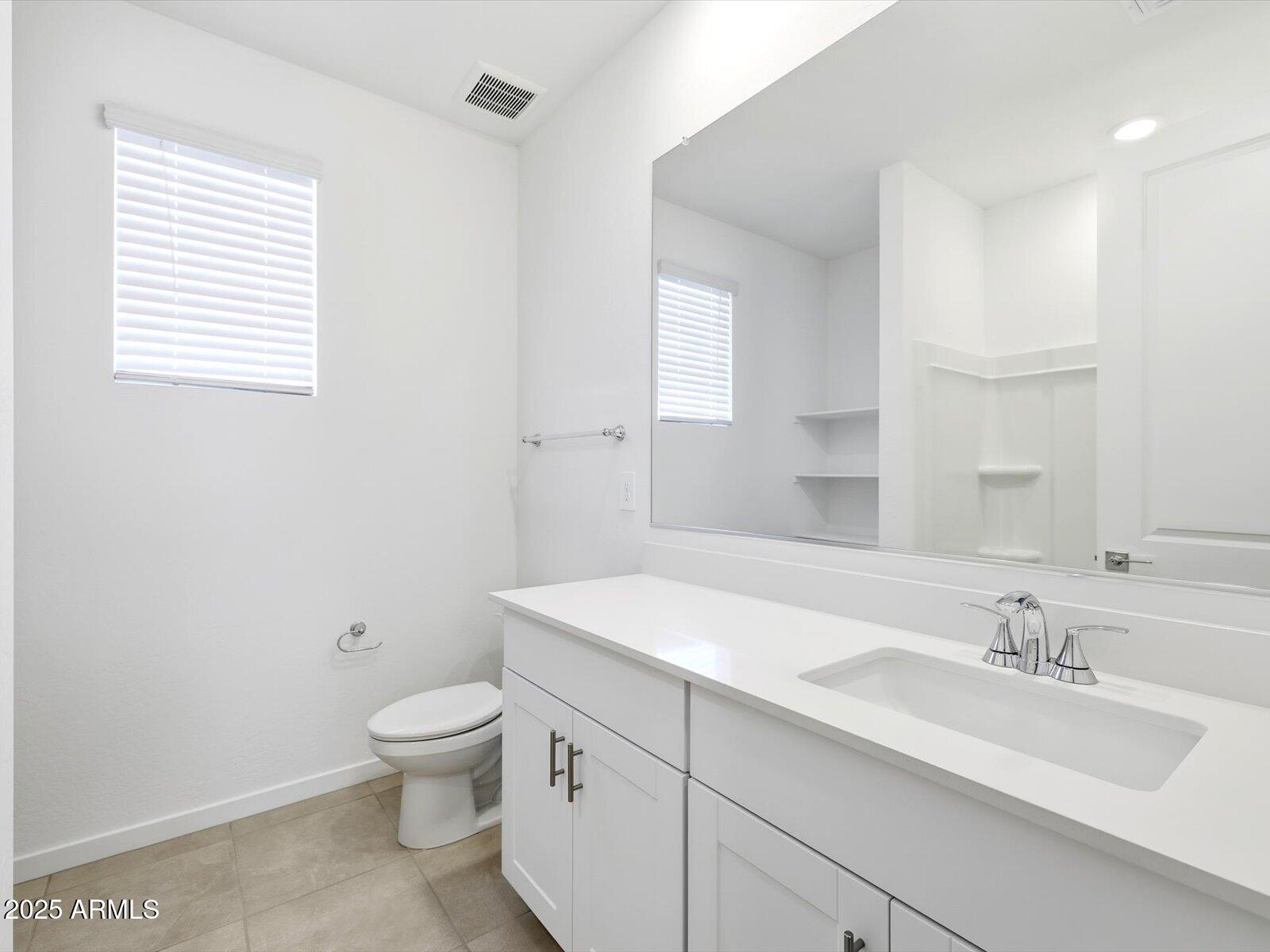 24477 West Grove Street Buckeye, AZ 85326 - Photo 21 of 49 a bathroom with a sink a toilet and a mirror