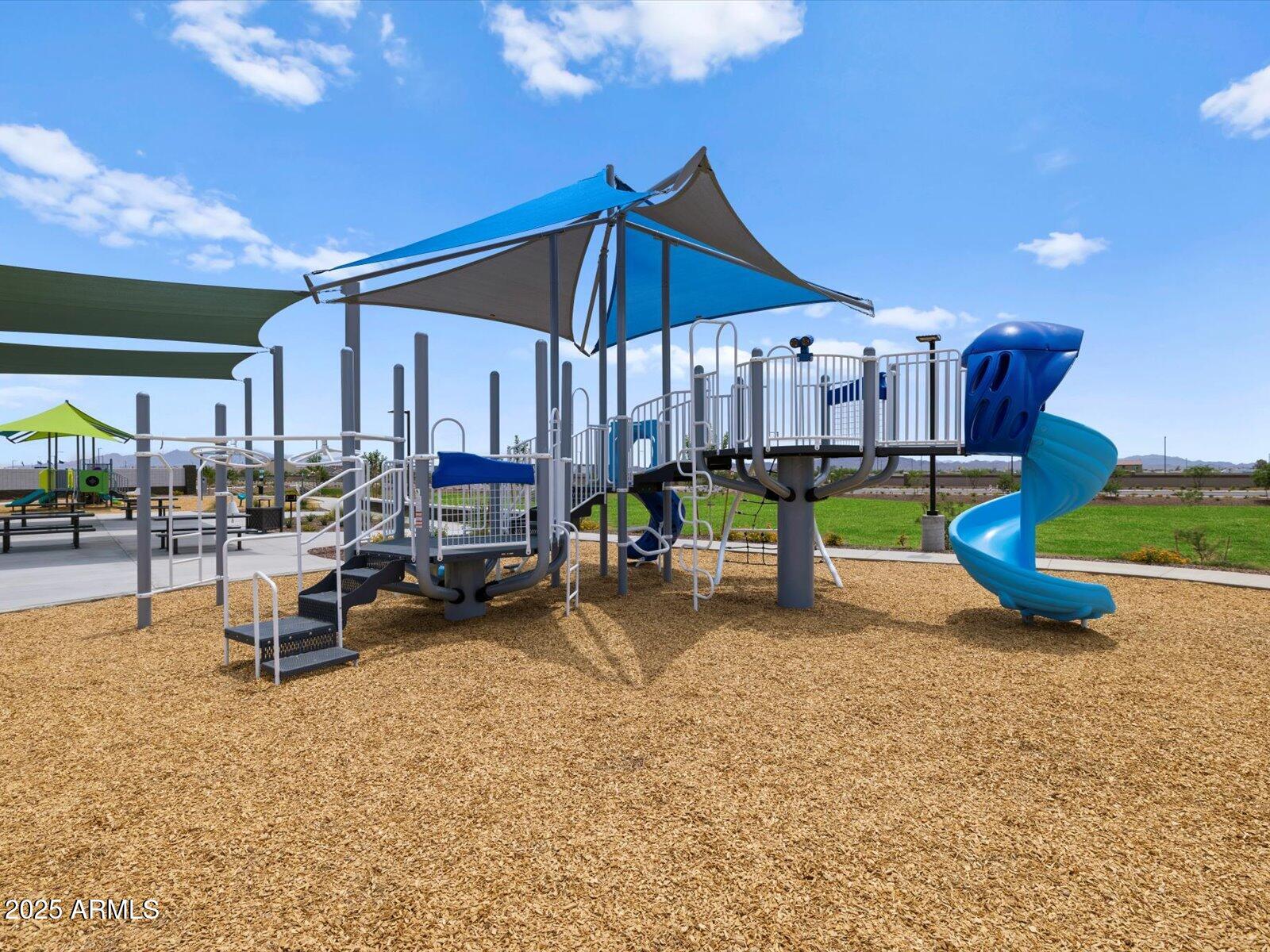 24477 West Grove Street Buckeye, AZ 85326 - Photo 44 of 49 a view of a swimming pool with chairs in patio