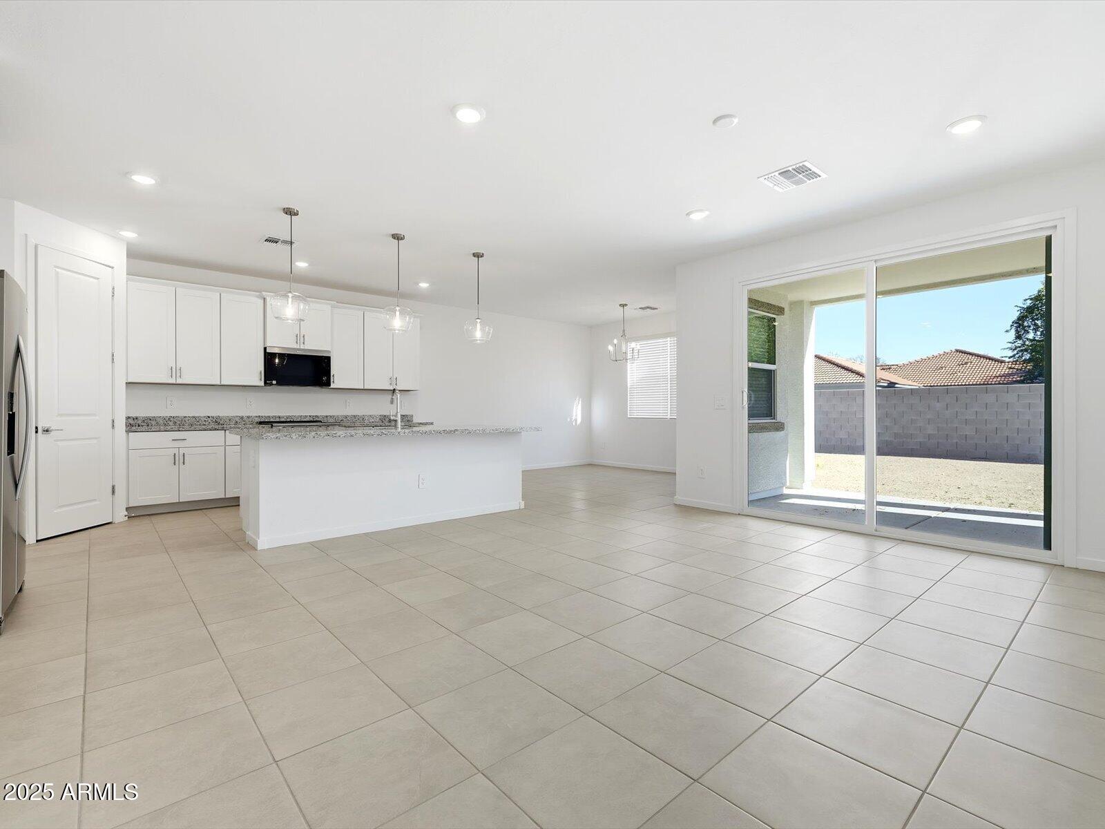24477 West Grove Street Buckeye, AZ 85326 - Photo 9 of 49 a view of a kitchen with an empty space and a window
