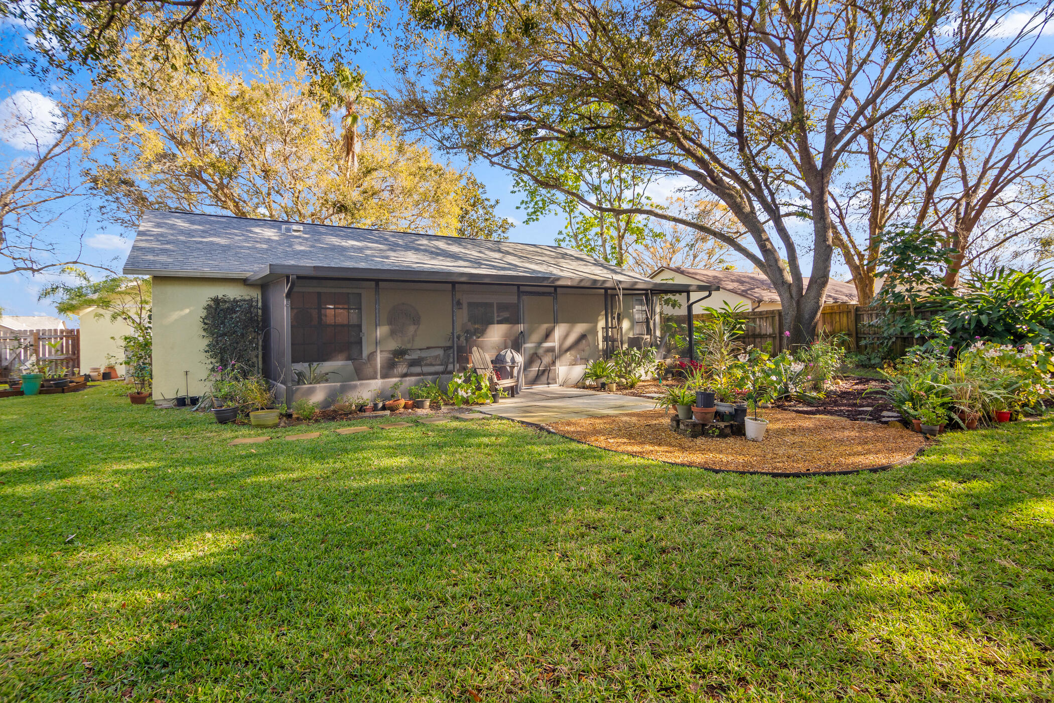 849 Gardener Road Rockledge, FL 32955 - Photo 26 of 31 a front view of a house with garden and a tree