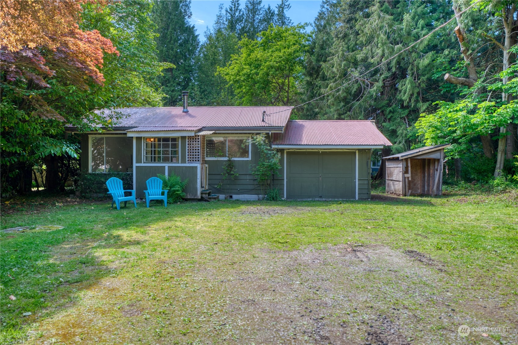 323 Mill Road Point Roberts, WA 98281 - Photo 1 of 26 a front view of a house with a garden