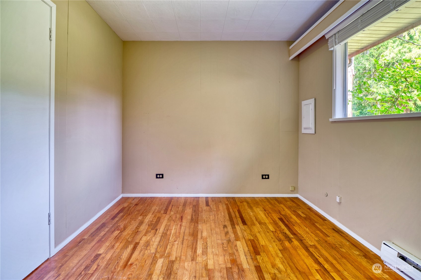323 Mill Road Point Roberts, WA 98281 - Photo 11 of 26 a view of a room with wooden floor and white walls