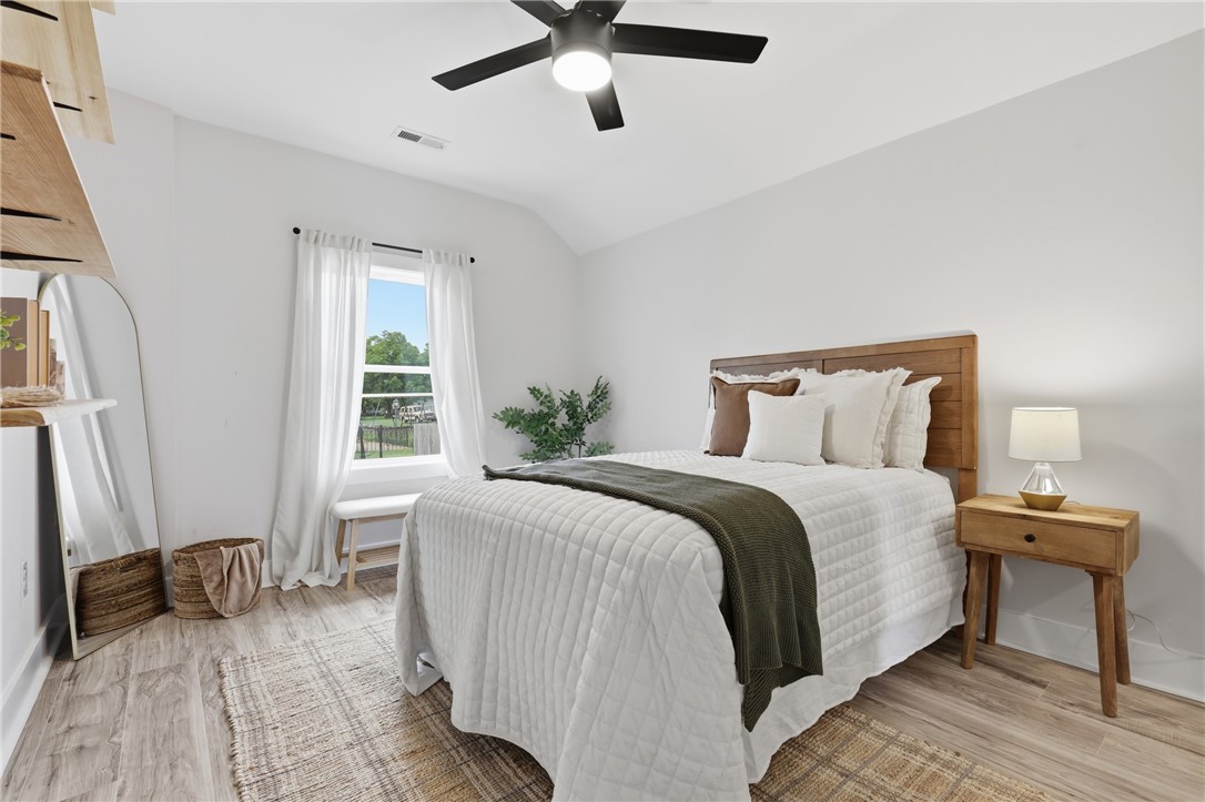 1 Brock Street Pelzer, SC 29669 - Photo 18 of 25 A quiet bedroom retreat features ample natural light and a practical ceiling fan for year-round comfort.