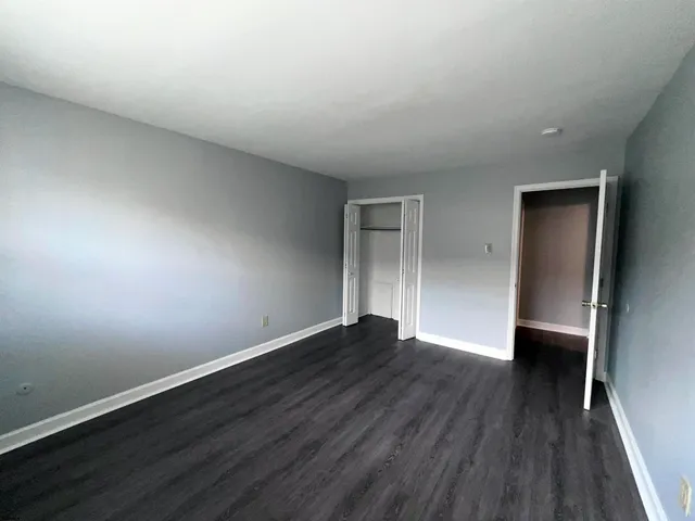 a view of an empty room and wooden floor