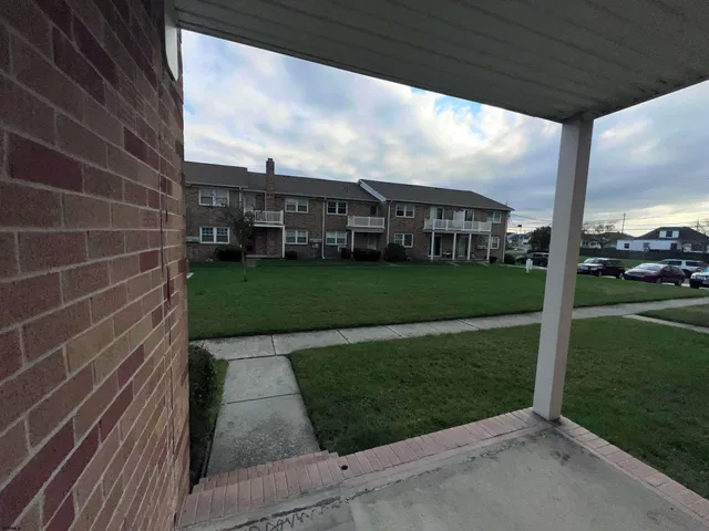 a view of a big room with a big yard plants and large trees