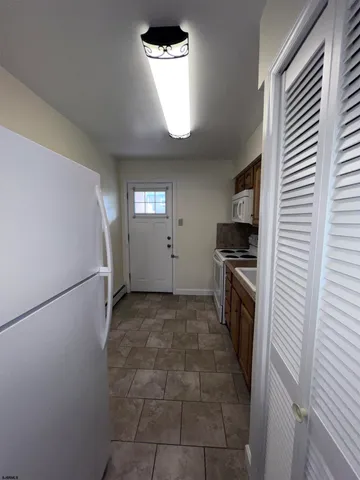 a kitchen with a refrigerator and a stove