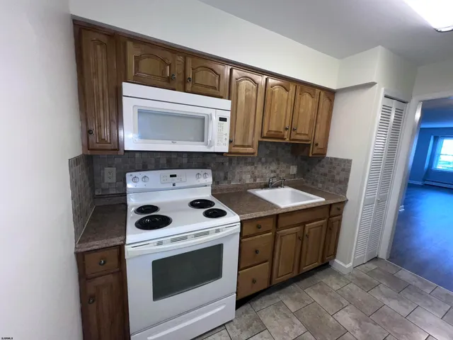 a kitchen with a stove microwave and sink