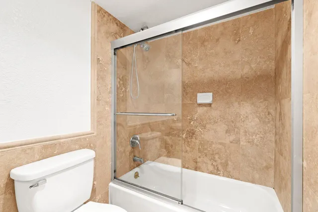 a bathroom with a shower and a toilet