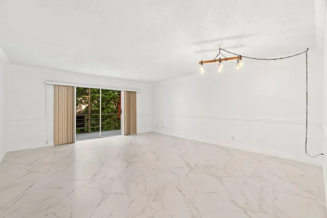 a view of an empty room with windows