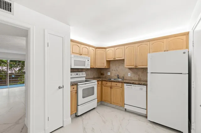 a kitchen with cabinets and stainless steel appliances