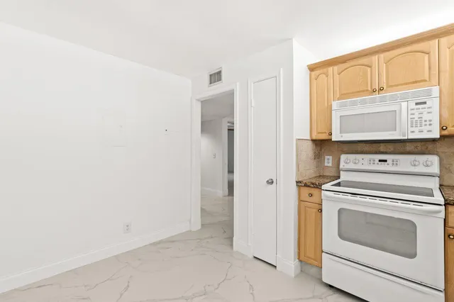 a view of washer and dryer with in a white cabinet