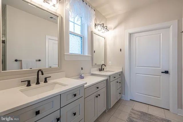 a living room with a large window and floor to ceiling windows