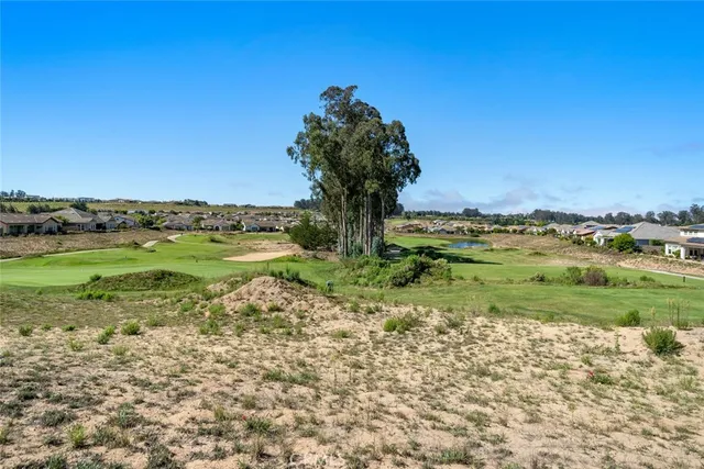 a spacious bedroom with a bed and a chandelier