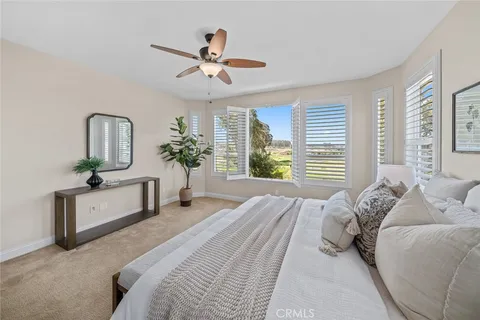 an empty room with closet and fan