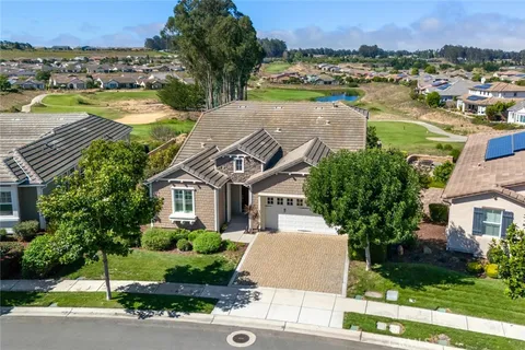 a aerial view of a house with a yard and lake view