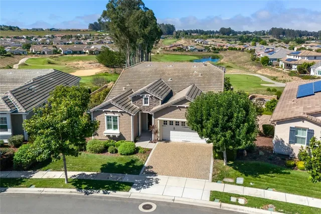 a aerial view of a house with a yard and lake view