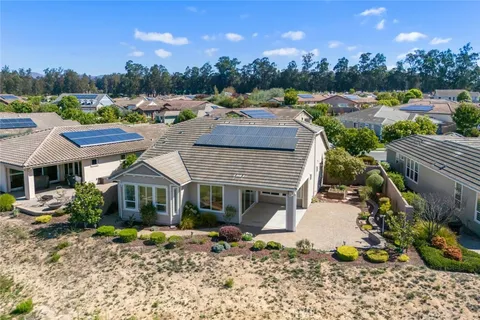 a view of a patio with couches table and chairs and potted plants