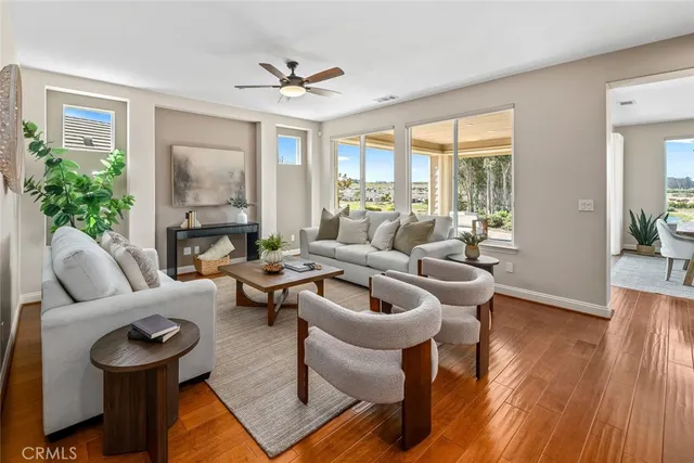 a living room with furniture and wooden floor