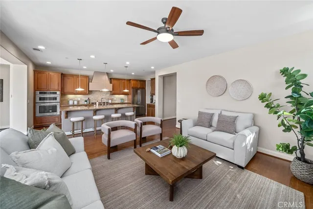 a living room with furniture kitchen view and a table