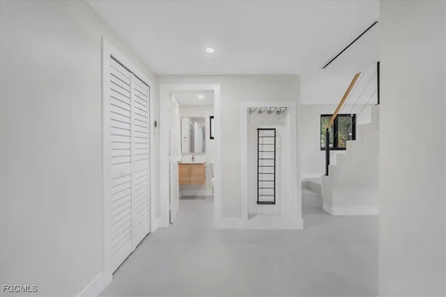a view of staircase with lots of frames on wall and a table