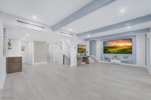 an empty room with windows and chandelier