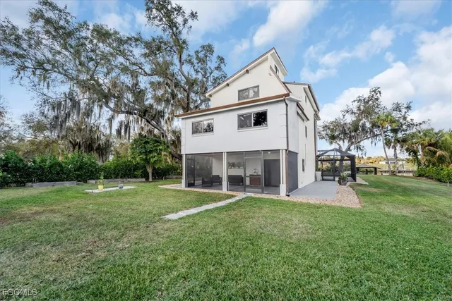 a view of a house with a yard and sitting area