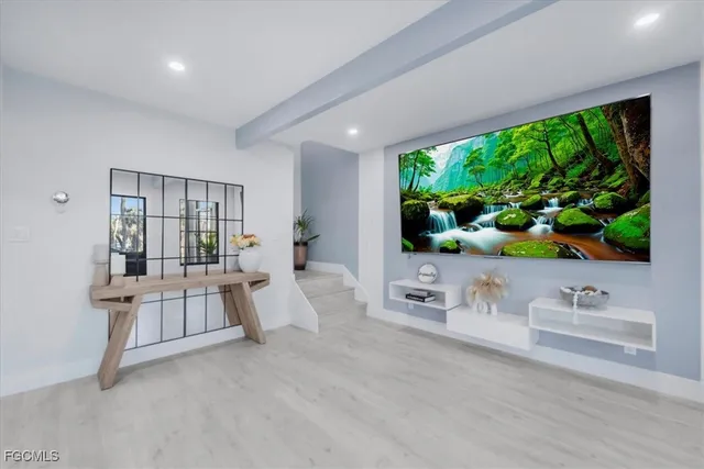 a view of an empty room with a window and fireplace