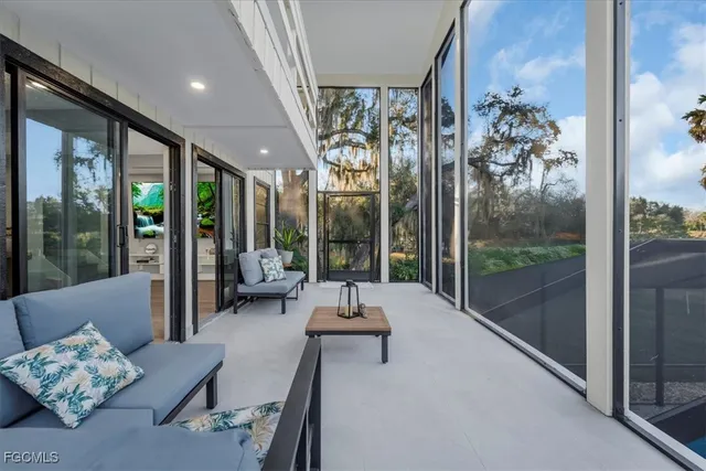 a living room with furniture and a floor to ceiling window