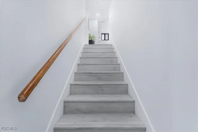 a spacious bedroom with a bed and a window