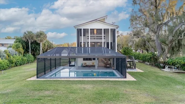 a view of a patio and yard in front of the house