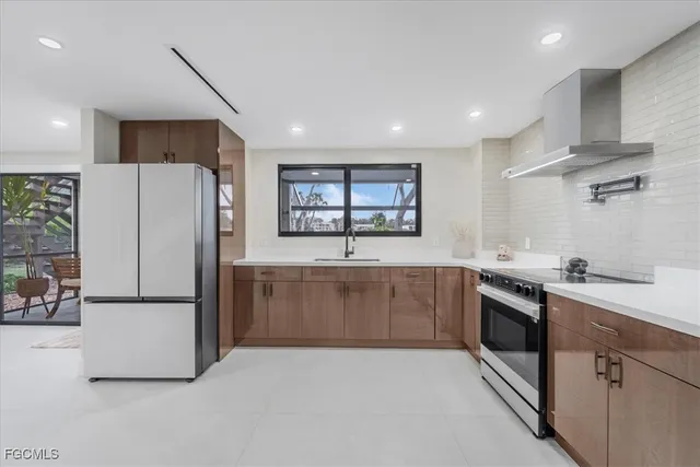 a kitchen with stainless steel appliances a refrigerator sink and stove