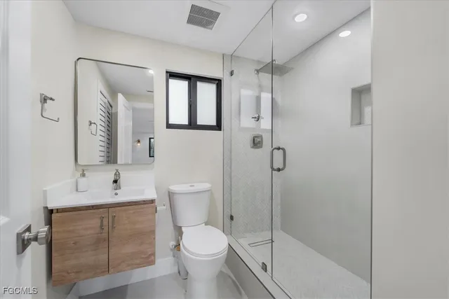 a bathroom with a toilet sink and shower