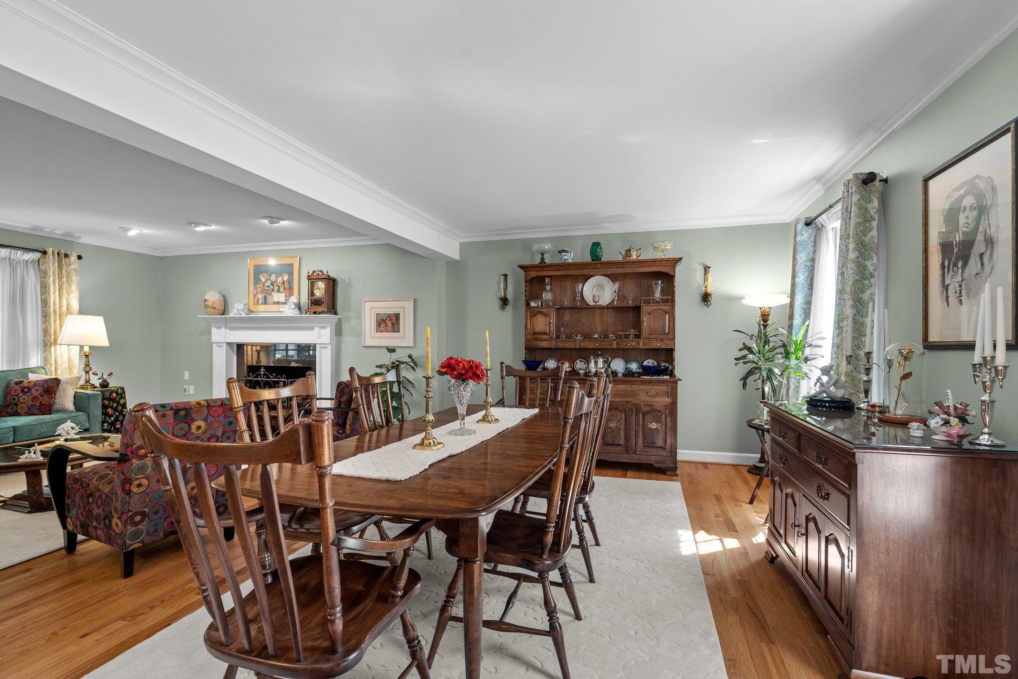 7805 Harps Mill Road Raleigh, NC 27615 - Photo 12 of 57 a view of a dining room with furniture window and wooden floor