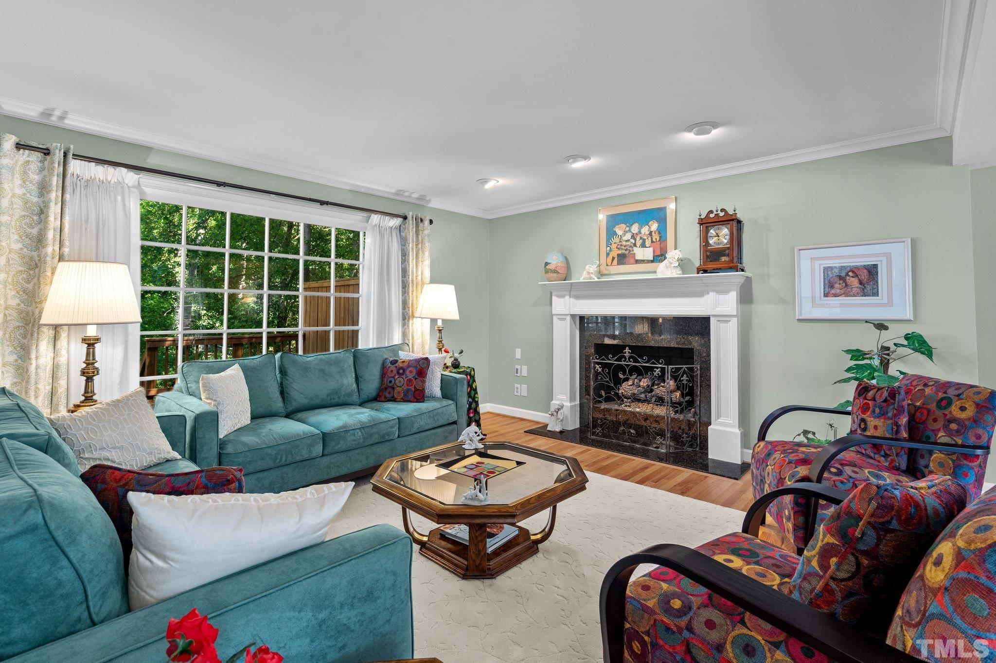 7805 Harps Mill Road Raleigh, NC 27615 - Photo 14 of 57 a living room with furniture and a fireplace