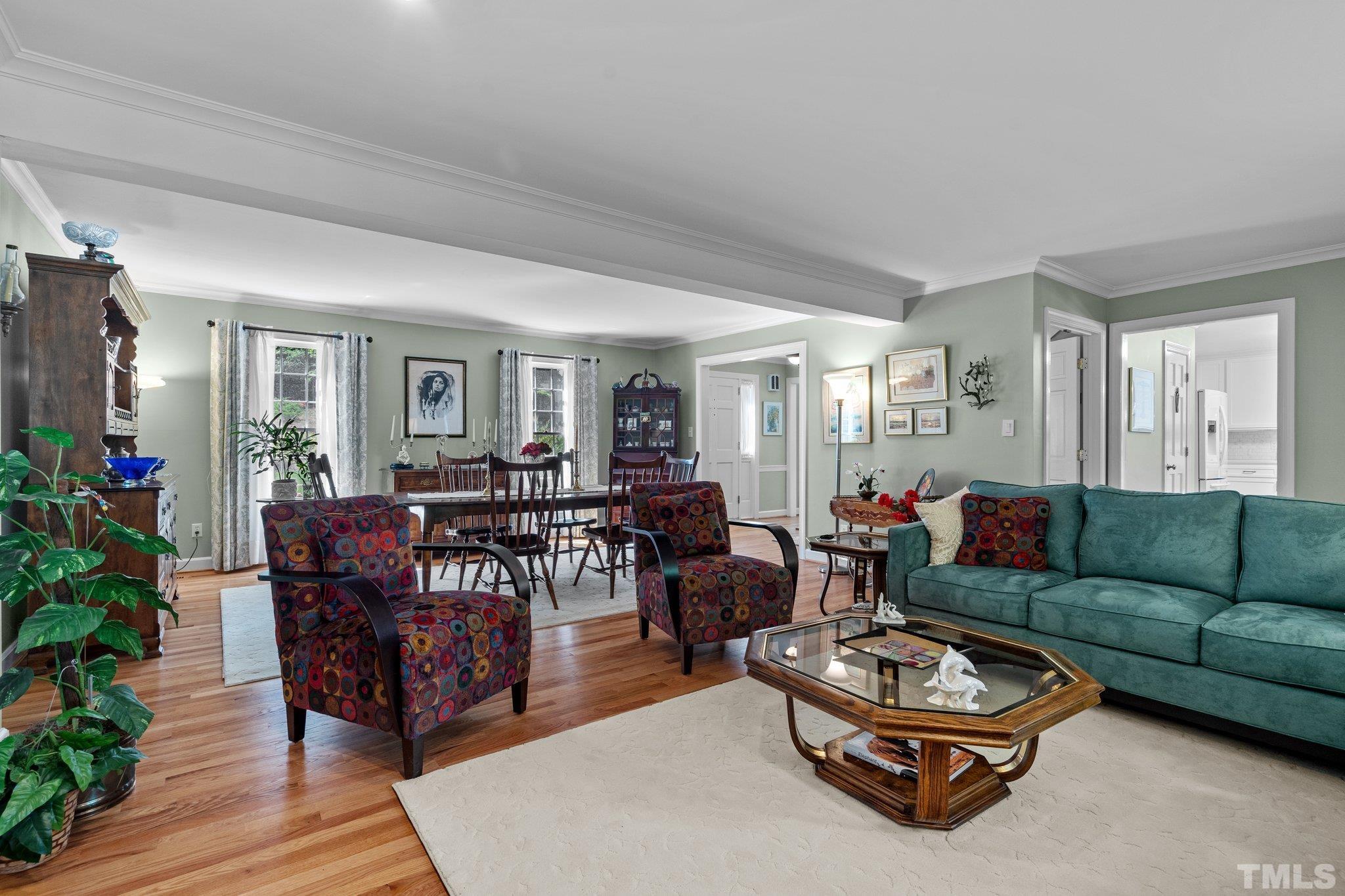 7805 Harps Mill Road Raleigh, NC 27615 - Photo 16 of 57 a living room with furniture and a potted plant
