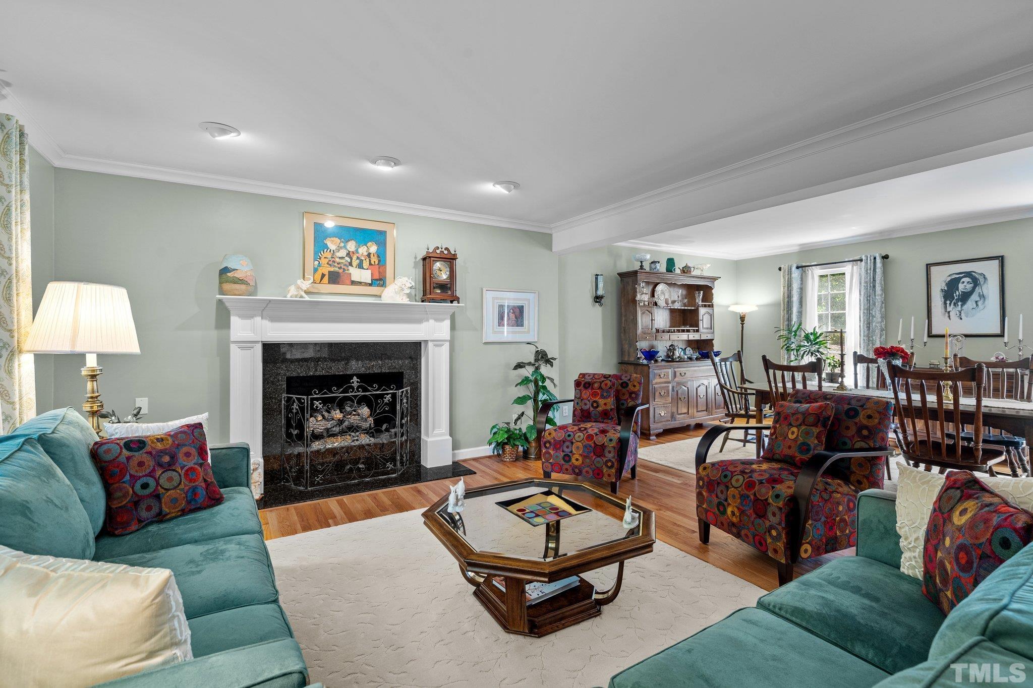 7805 Harps Mill Road Raleigh, NC 27615 - Photo 17 of 57 a living room with furniture and a fireplace